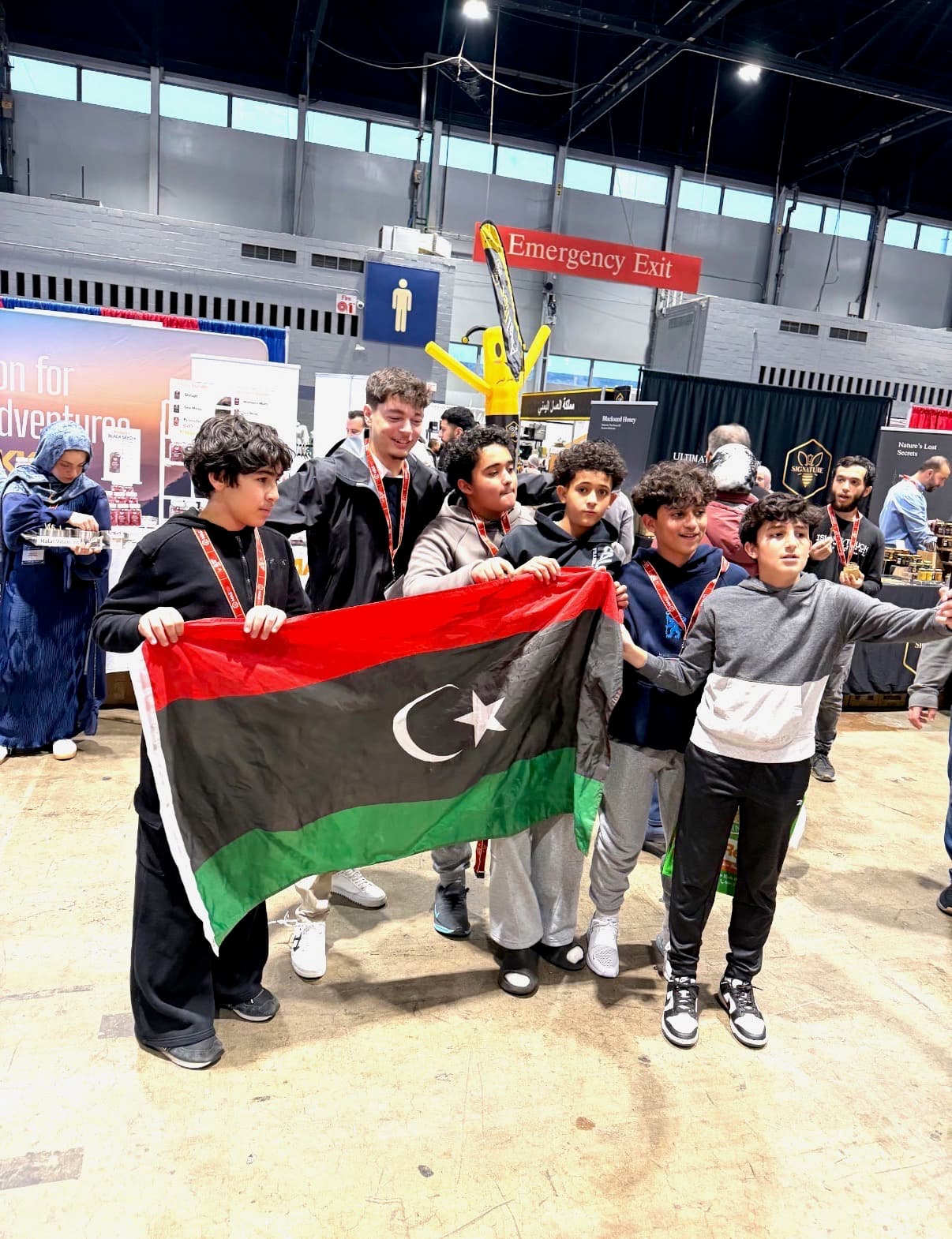 Awad Buisir with Libyan youth holding the Libyan flag